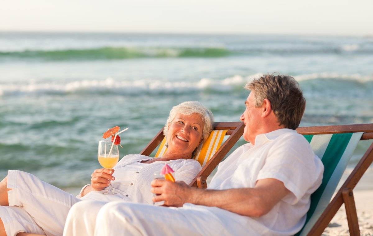 insured seniors having a cocktail by the sea